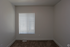 Bright room with cozy carpet flooring and large window blinds, perfect for a tranquil ambiance.