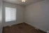 Bright room with plush carpet and a modern ceiling light, perfect for creating a cozy space.
