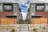 Contemporary apartment complex with modern architecture, featuring brick and metal accents and a welcoming pathway.
