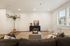 Elegant living room with plush seating, stylish decor, and abundant natural light filtering through large windows.