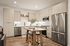 Modern kitchen with sleek cabinetry, stainless steel appliances, and a cozy dining area with a stylish wooden table.