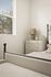 Bright and cozy bedroom with elegant furnishings, featuring a stylish iron bed and a chic dresser beside a sunlit window.