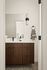 Elegant bathroom featuring a sleek wooden vanity, modern fixtures, and sophisticated lighting.