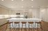 Modern kitchen with sleek cabinetry, island seating, stainless steel appliances, and elegant lighting.