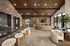 Luxury interior showcasing a spacious open-plan lounge with a stylish wooden ceiling, plush seating, a modern fireplace, and a sleek bar with faux fur stools, perfect for entertaining.