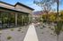 Modern apartment complex with a stylish outdoor patio, mountain views, and lush landscaping.