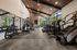 Contemporary fitness center with state-of-the-art equipment, high ceilings, and large windows offering natural light and scenic views.