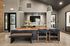 Modern apartment dining area with elegant wooden table, stylish seating, and accent lighting, featuring contemporary decor and open-space design.