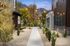 Charming walkway adorned with twinkling lights, surrounded by beautiful landscaping and stunning mountain vistas.