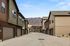 Elegant townhouse community with modern architecture, nestled under breathtaking mountain views and a clear blue sky.