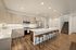 Luxurious modern kitchen with elegant cabinetry, stainless steel appliances, and a chic island with stylish bar stools.