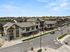 Charming modern townhouse complex with a sleek design in a tranquil suburban neighborhood, offering inviting pathways and lush greenery.