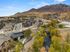 A charming residential community nestled in a scenic valley with picturesque mountain views and a serene river flowing nearby.