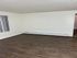 Modern apartment interior showcasing elegant wood flooring and a bright, open space perfect for cozy living.