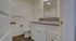 Chic modern bathroom with elegant granite countertop, sleek fixtures, and ample natural light.