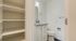 Chic bathroom with elegant vanity and ample shelving, offering a blend of functionality and style.
