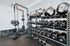 Modern fitness center with diverse free weights, kettlebells, and advanced strength equipment.