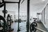 Modern fitness center with state-of-the-art equipment, spacious layout, and ample natural light.