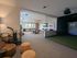 Modern recreational room featuring a pool table, golf simulator, and stylish seating area for relaxation and entertainment.