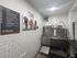 Modern pet wash station with stainless steel sink, bright lighting, and cheerful dog artwork, offering convenience for pet owners.