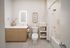 Elegant bathroom featuring modern vanity, illuminated mirror, and a pristine bathtub. Thoughtful storage solutions and stylish decor create a serene spa-like atmosphere.
