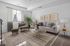 Charming living room with elegant decor, featuring a cozy sofa, stylish armchair, and vibrant houseplants, perfect for relaxation.