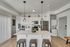 Contemporary kitchen with sleek appliances, stylish pendant lights, and a spacious island for a modern culinary experience.
