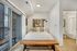 Inviting bedroom with modern decor, featuring a comfortable bed, elegant wall art, and a cozy balcony view.