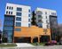 Modern apartment building with stylish architecture, large windows, and balconies, offering upscale urban living.