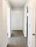 Bright and welcoming hallway with plush carpeting and built-in storage, offering seamless access to multiple rooms.