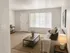 Inviting living room with plush sofa, warm lighting, and natural light streaming through large window.