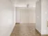 Bright and spacious room featuring elegant tile flooring and vertical blinds, perfect for a modern living area.