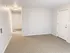 Bright and welcoming entryway featuring plush carpet and modern lighting in a cozy apartment.