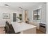 Modern kitchen with elegant island, stylish patterned backsplash, sleek stainless steel appliances, and large window providing natural light.
