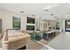 Inviting contemporary lounge with stylish seating, modern lighting, and a sleek shuffleboard table.