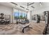 Modern gym with mountain view, featuring treadmills, exercise bike, and full set of fitness equipment for an inspiring workout.