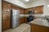 Modern kitchen with elegant wooden cabinets, stainless steel appliances, and granite countertops.
