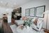 Contemporary open-plan living area with an elegant kitchen, cozy sofa, and stylish decor accents.