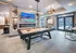 Elegant game room with a sleek pool table, cozy fireplace, and modern decor, offering a perfect space for relaxation and entertainment.