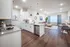 Modern open-plan apartment with sleek kitchen, bright living area, and elegant d&eacute;cor, showcasing contemporary design and cozy ambiance.