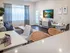 Chic open-concept living room with plush seating, modern decor, and bright natural lighting, perfect for relaxation and entertaining.