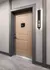 Elegant and modern apartment entrance with stylish door and illuminated unit number, offering a warm welcome in a luxurious building.