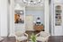 Elegant apartment lobby showcasing modern design with tall columns, plush seating, and stylish decor.