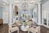 Elegant living area with high ceilings, large windows, and modern furnishings, offering a cozy and sophisticated ambiance.