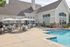 Inviting outdoor area featuring a pristine swimming pool and elegant patio seating, ideal for relaxation and gatherings.