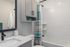 Modern bathroom with sleek subway tiles, stylish sink, and striped shower curtain in a bright setting.