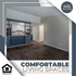 Inviting living space with rich hardwood floors, modern partition, and abundant natural light in The Farms at Mill Run.