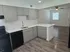 Modern kitchen with sleek grey cabinetry, elegant countertops, and open floor plan perfect for entertaining.