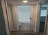 Inviting hallway with elegant flooring leading to a bright, modern bathroom and bedroom.
