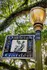 Charming street sign for Oakleigh Historic District Garden, surrounded by lush greenery and elegant lamp post.